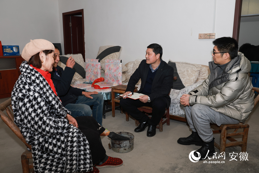 臨近全國(guó)兩會(huì)，楊廣奇（右二）走村串戶，與村民交談。人民網(wǎng) 張俊攝