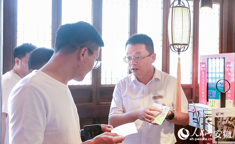 朱斌（右）推介“古村”文創(chuàng)產品。人民網記者 張俊攝