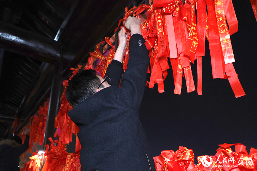 市民系上紅繩，許下美好愿望。人民網(wǎng)記者 周坤攝